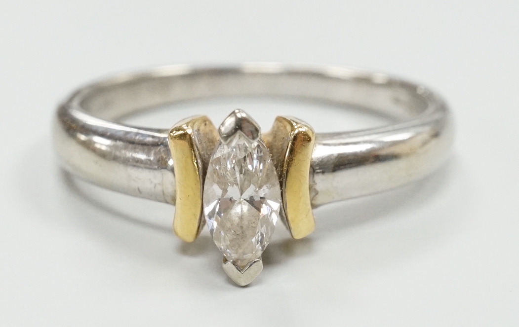 A modern two colour 18ct and solitaire marquise cut diamond set ring, size M/N, gross weight 3.6 grams.
